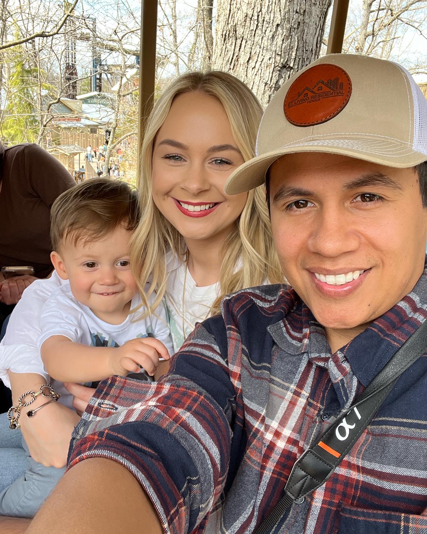 Eric Zuniga with his wife and son, wearing an EZ Living hat
